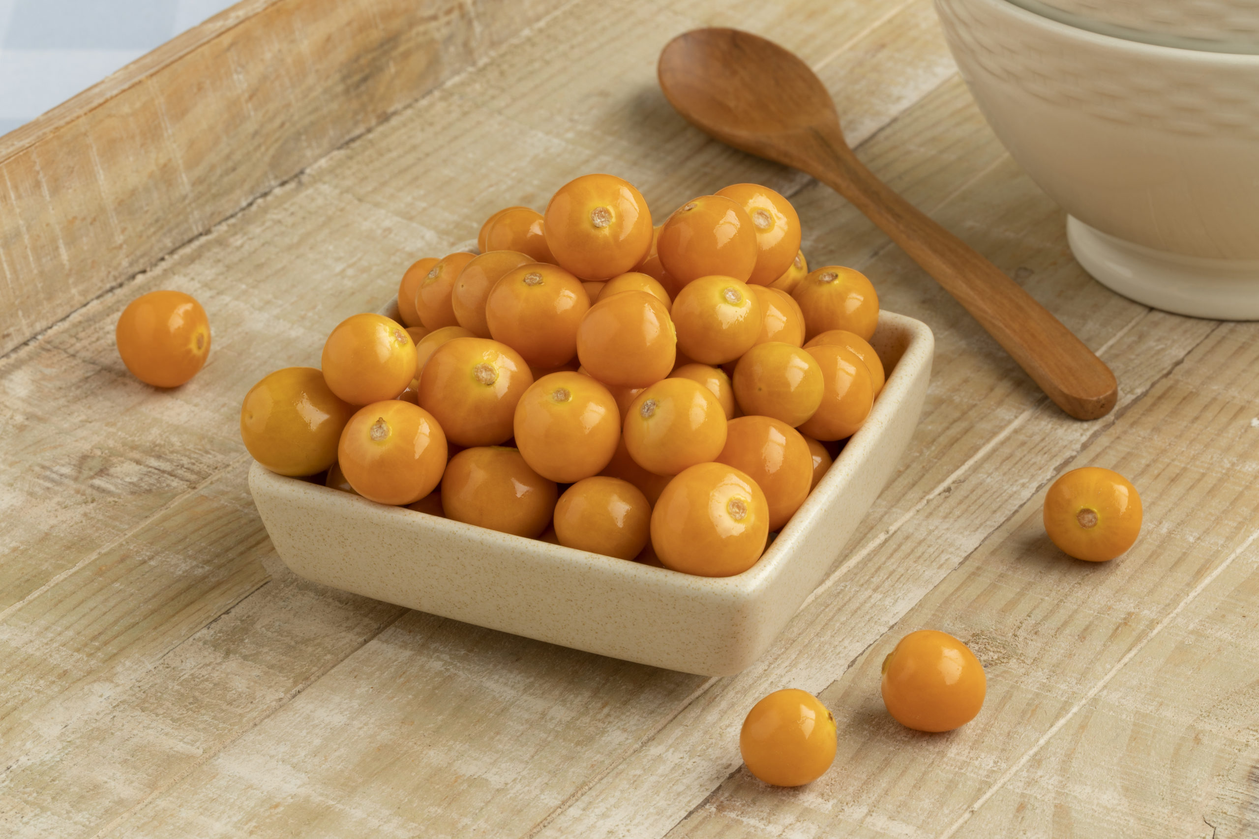 Bowl with fresh ripe orange goldenberries close up on a table